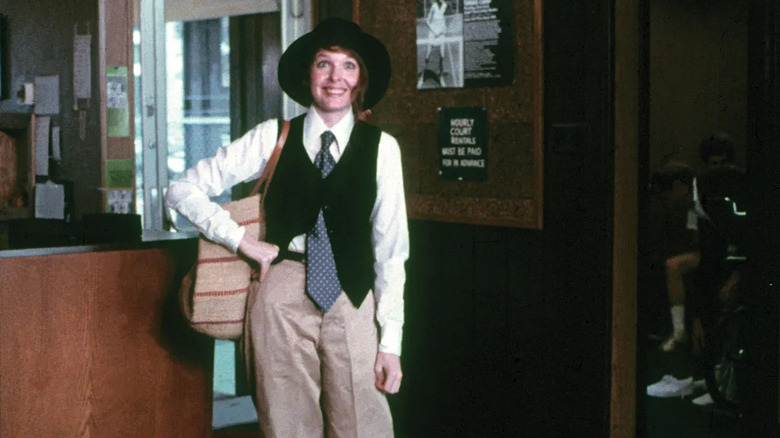 Annie wearing a hat and vest with her hand on her hip in Annie Hall