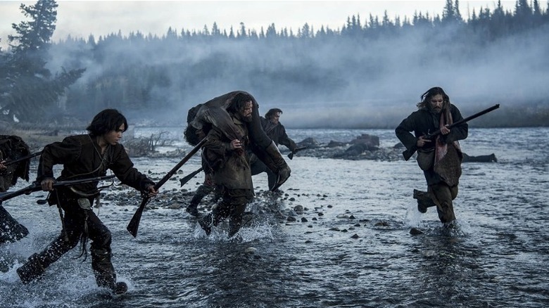 Armed men running in the river