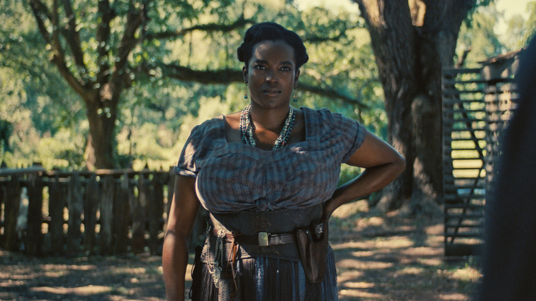 Annie with one hand on her hip in Sinners