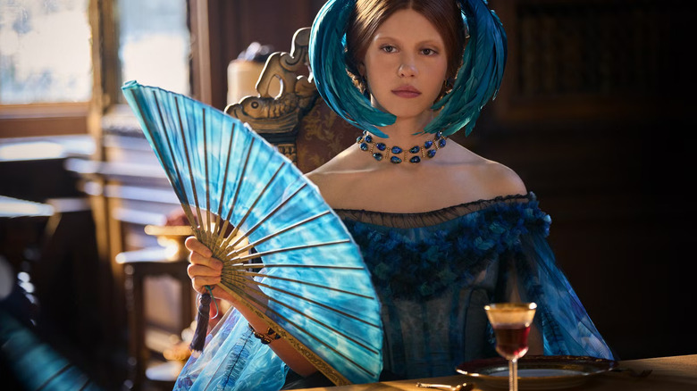 Elizabeth in a blue dress holding a fan in Frankenstein