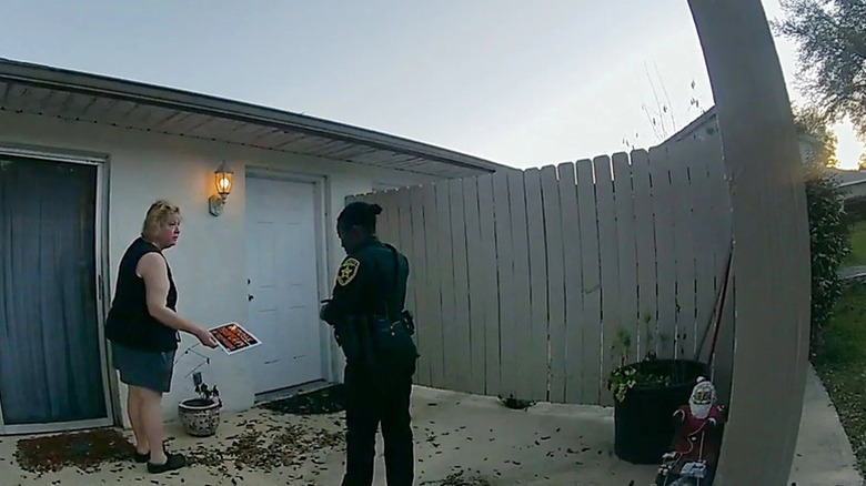 Police officer confronting a woman in The Perfect Neighbor