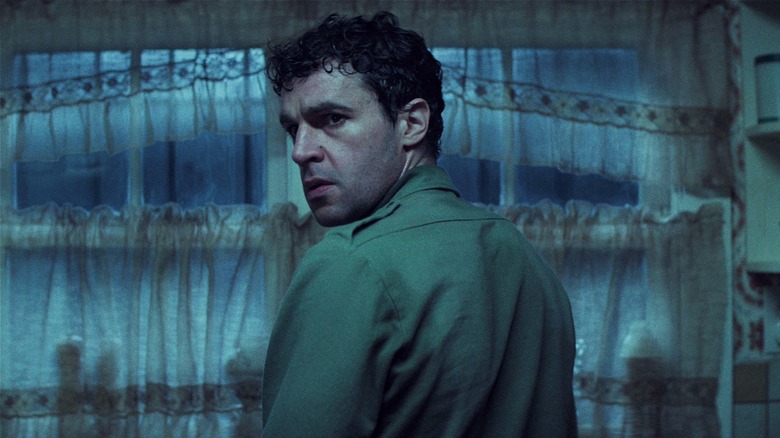 Blake looking behind himself alarmed in Wolf Man (2025)