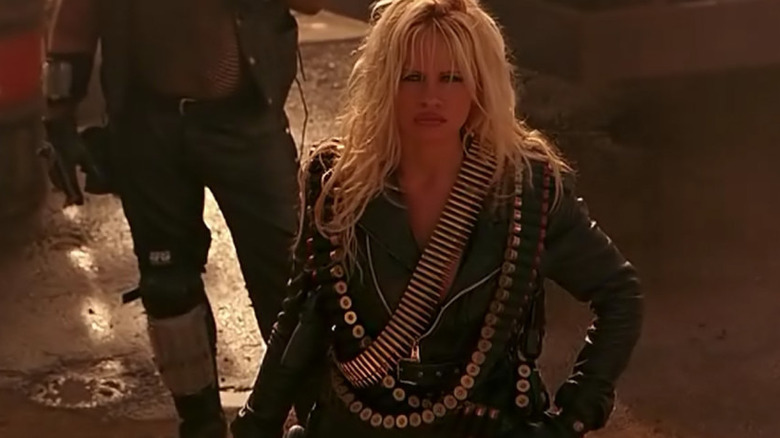 Barb standing outside decked out in leather in Barb Wire (1996)