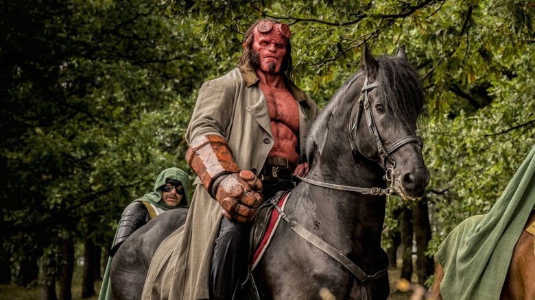 Hellboy riding a black horse in Hellboy (2019)