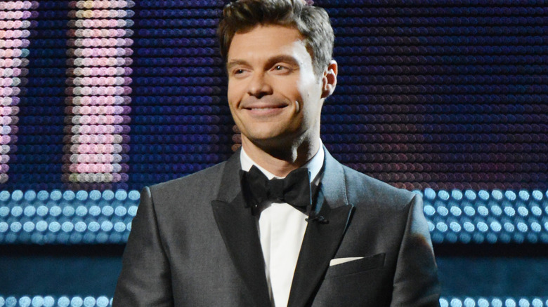 Ryan Seacrest smiling wearing tux