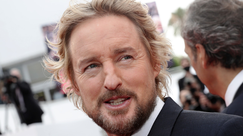 Owen Wilson smiling in a tuxedo at Cannes 2021