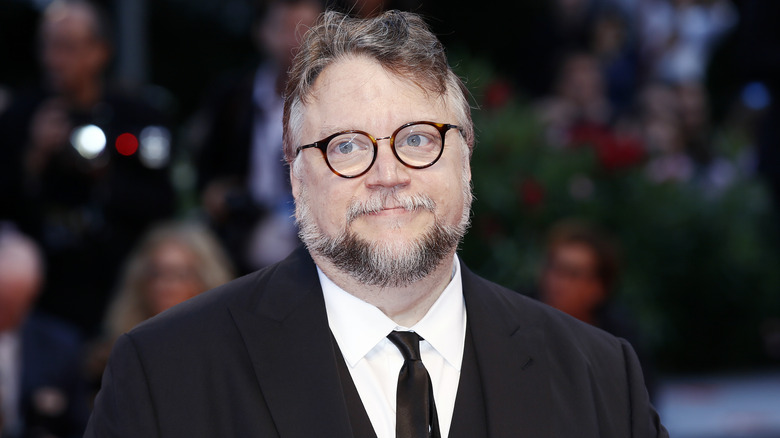 Guillermo del Toro wearing suit and glasses