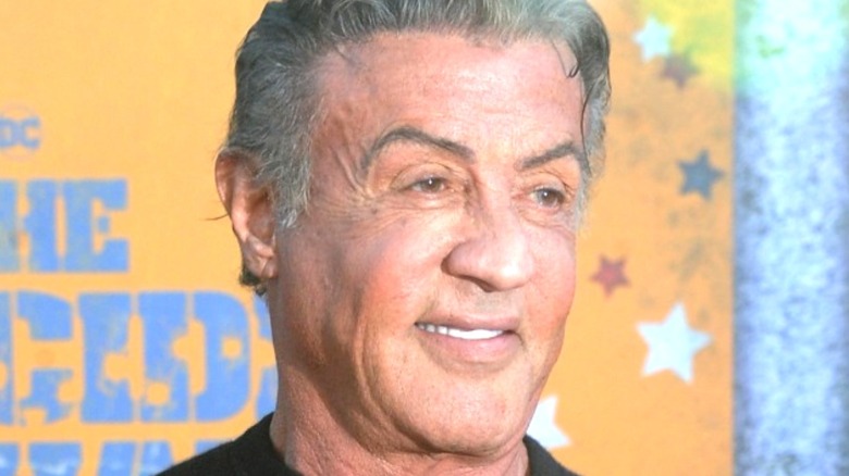 Sylvester Stallone smiling for photographers 