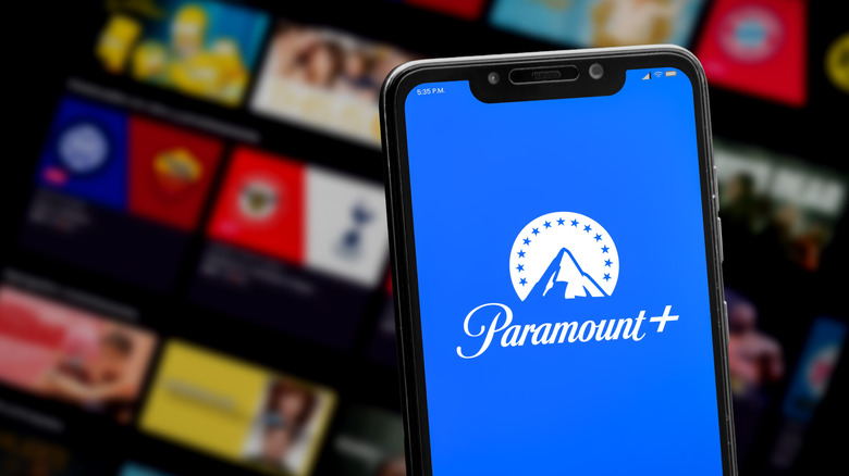 Phone with Paramount+ logo in front of TV