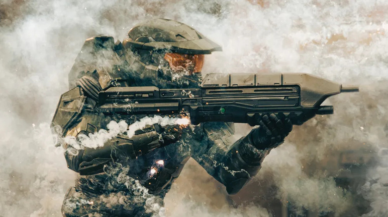 Master Chief fires his rifle through smoke in Halo
