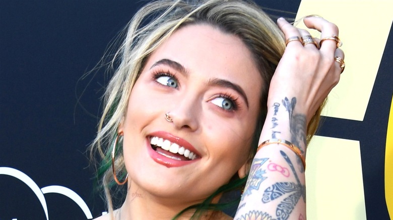 Paris Jackson touching her hair