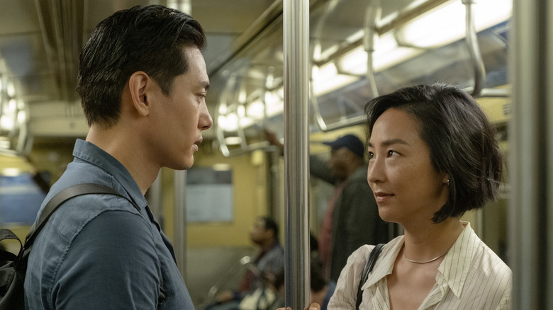 Nora and Hae-Sung smiling on train