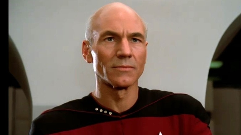 Picard stands in front of a wall