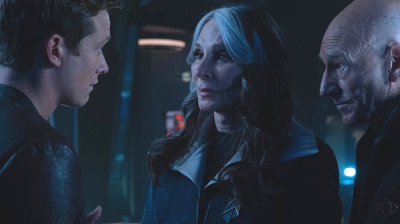Jean-Luc Picard, Beverly Crusher, and Jack Crusher talk in a darkened sickbay