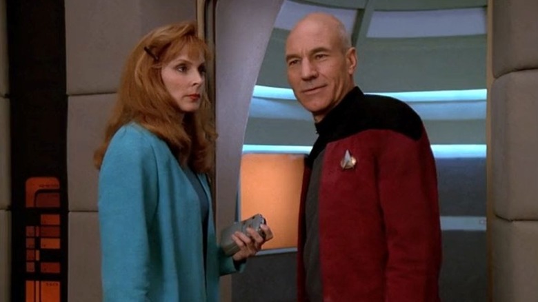Dr. Beverly Crusher stands next to Jean-Luc Picard on the USS Enterprise in Star Trek: The Next Generation