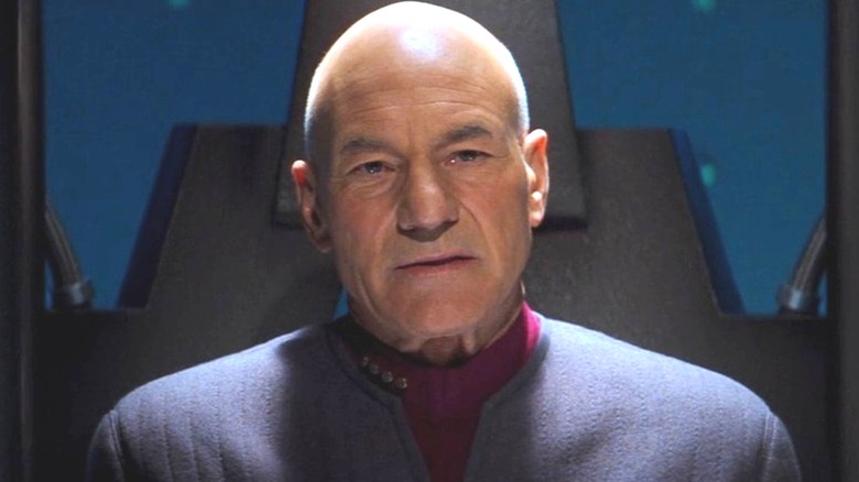 Picard stands inside a restraining device