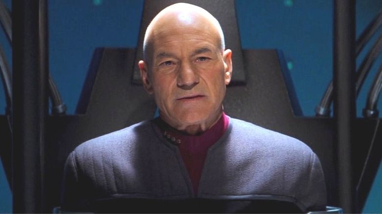 Picard stands inside a restraining device