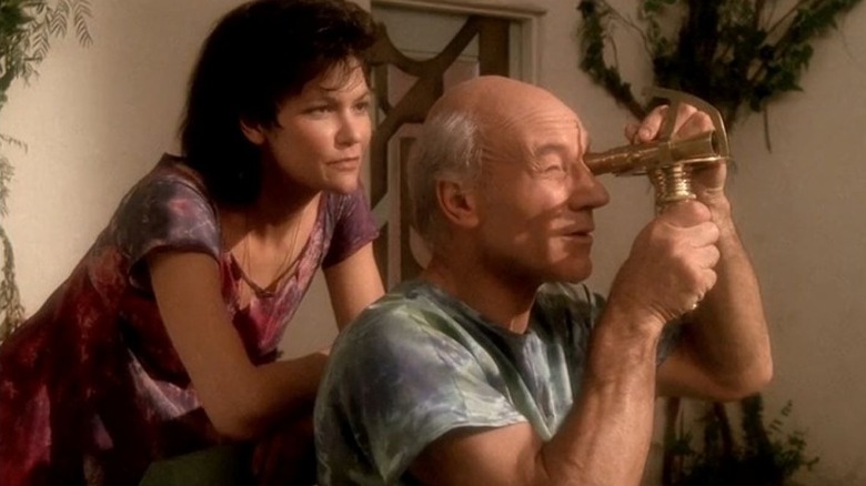 Eline stands behind Jean-Luc Picard as he looks through a sextant in Star Trek: The Next Generation