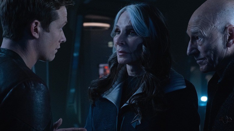 Jean-Luc Picard, Beverly Crusher, and Jack Crusher talk in a darkened sickbay
