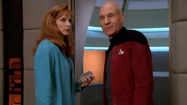 Dr. Beverly Crusher stands next to Jean-Luc Picard on the USS Enterprise in Star Trek: The Next Generation