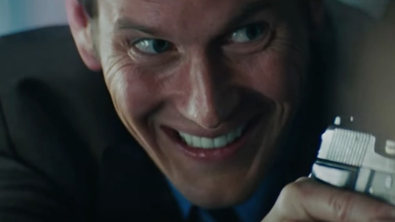 Agent Lynch pointing a gun