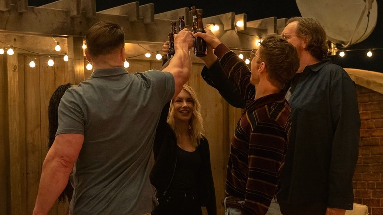 Peacemaker and friends clink beer bottles in Peacemaker Season 2