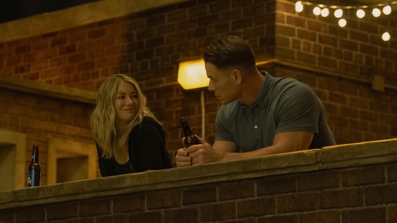 Harcourt and Chris have beers on a rooftop in 