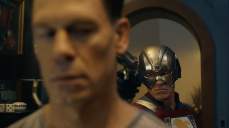 One universe's Peacemaker aims a gun at another in "Peacemaker" Season 2
