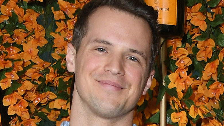 Freddie Stroma against floral background