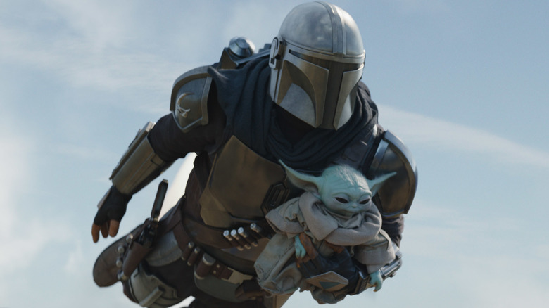 The Mandalorian flying with Grogu