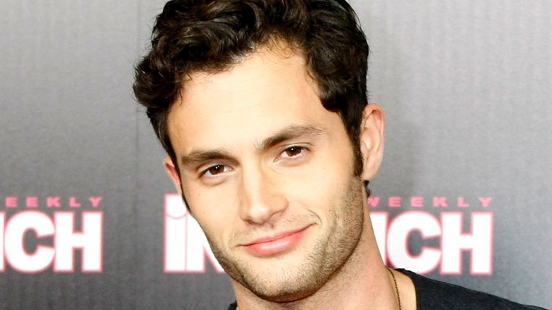 Penn Badgley smirking