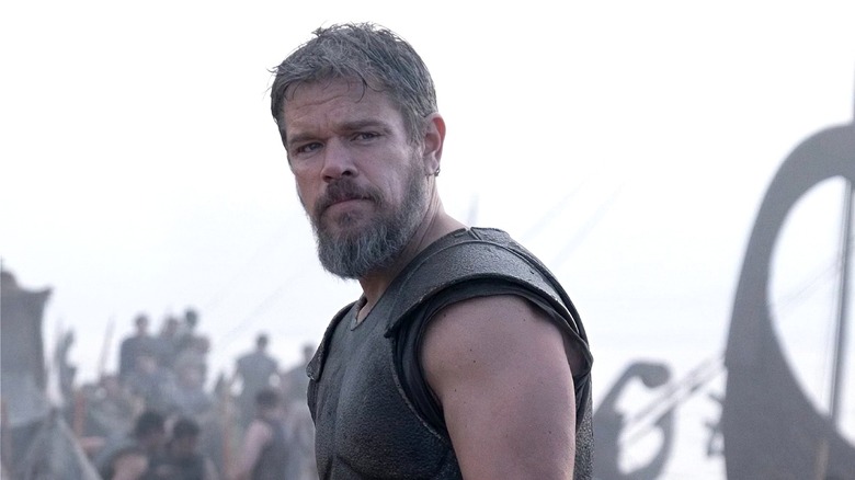 Odysseus looks up with a gray sky behind him in 