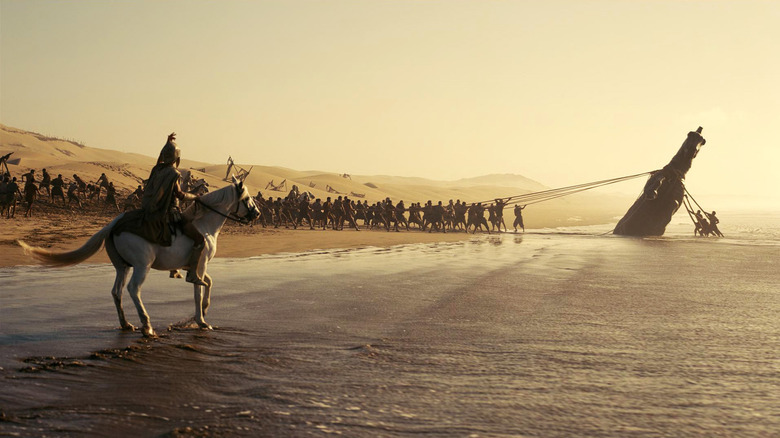 Trojans pull the Trojan Horse out of the ocean in "The Odyssey" (2026)