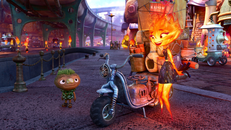 Ember stands beside motorcycle, smiling at Clod