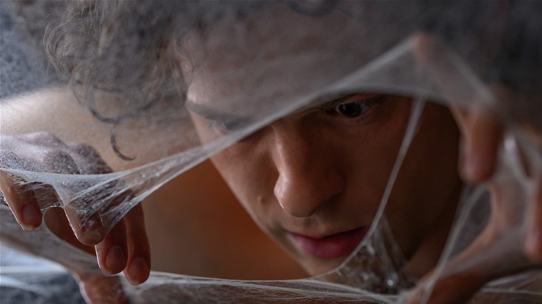 Peter Parker looking at webs close-up and confused in Spider-Man: Brand New Day