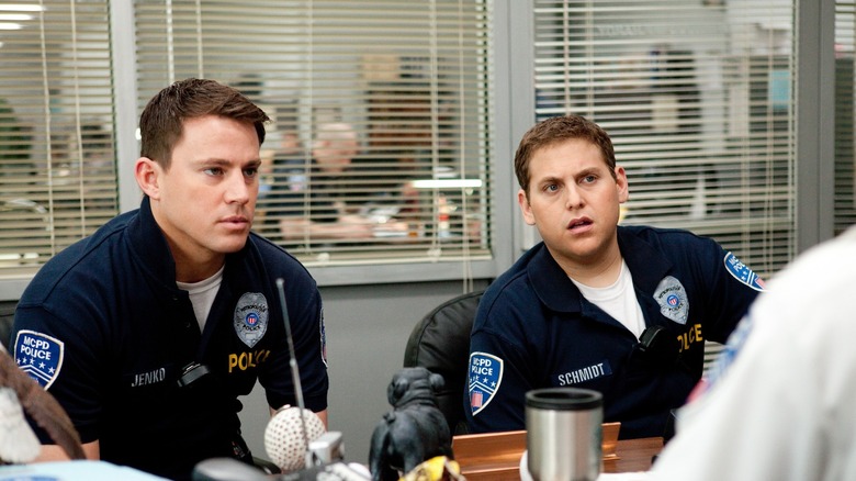 Jenko and Schmidt in police uniform, looking dismayed from behind a supervisor's desk in 21 Jump Street (2012)