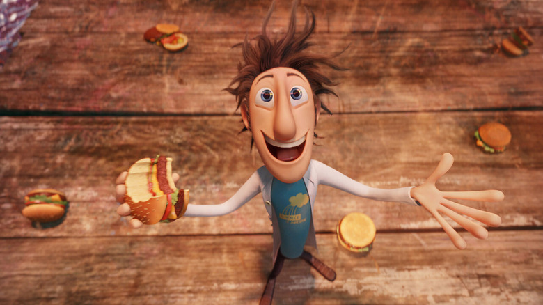 Animated character Flint grinning with a burger in his hand in Cloudy With a Chance of Meatballs