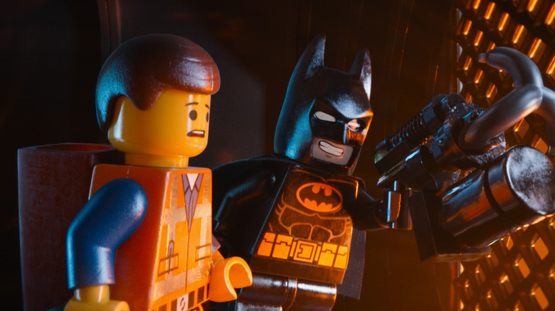 Emmett and Lego Batman preparing to use a grappling hook in The Lego Movie