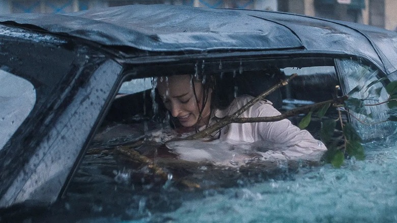 Lisa trapped in a car during a flood in Thrash