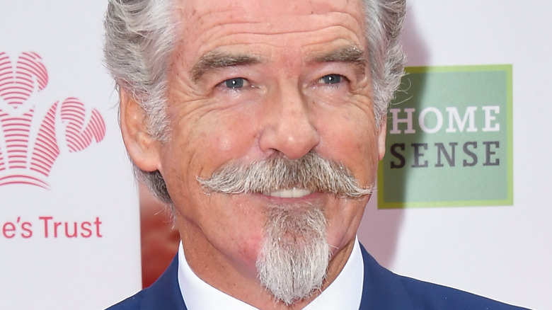 Pierce Brosnan smiling at event