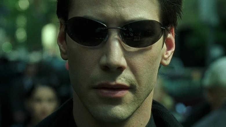 Neo walking in sunglasses