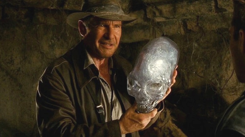 Indiana Jones holds up a crystal skull and smiles in Kingdom of the Crystal Skull (2008)