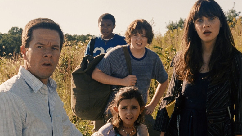 Elliot, Alma, and three kids stand in a wheat field staring into the distance in The Happening (2008)