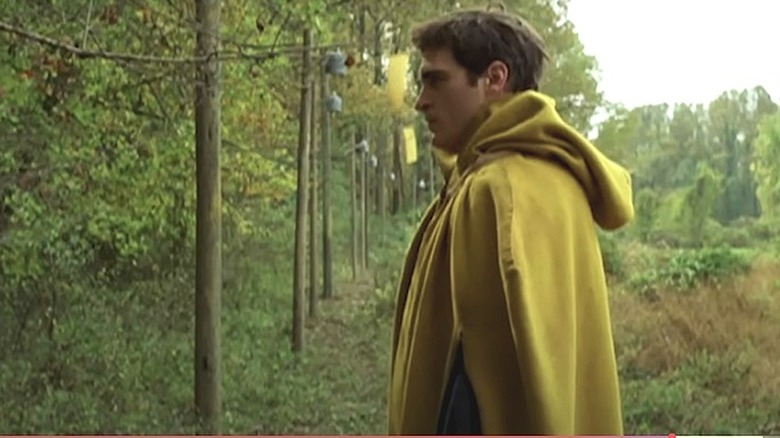 Lucius Hunt wearing a yellow poncho in Thee Village (2004)
