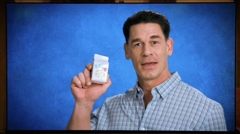 John Cena holds a milk carton on a TV in "Pluribus"