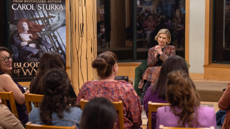 Carol addresses a book reading group in "Pluribus" (2025)