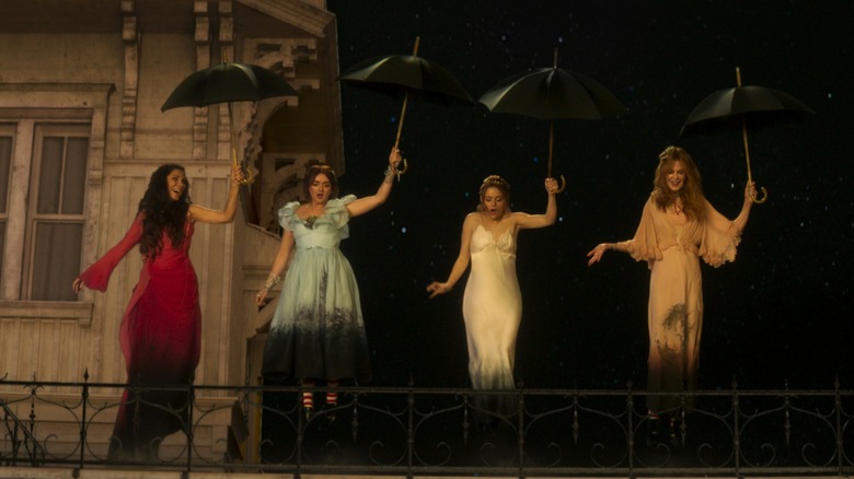 Sally, Antonia, Kylie, and Gillian holding umbrellas on a rooftop in Practical Magic 2 (2026)
