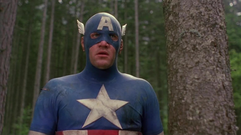 A disheveled Captain America standing in woods (1990)