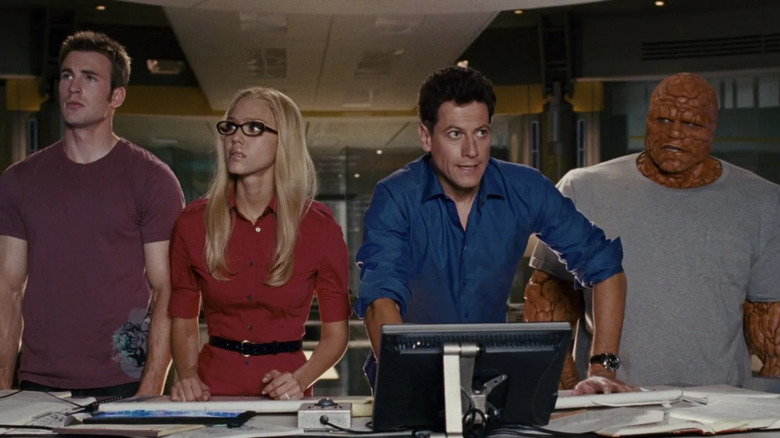 Johnny, Sue, Reed, and the Thing looking concerned at screen (2007)