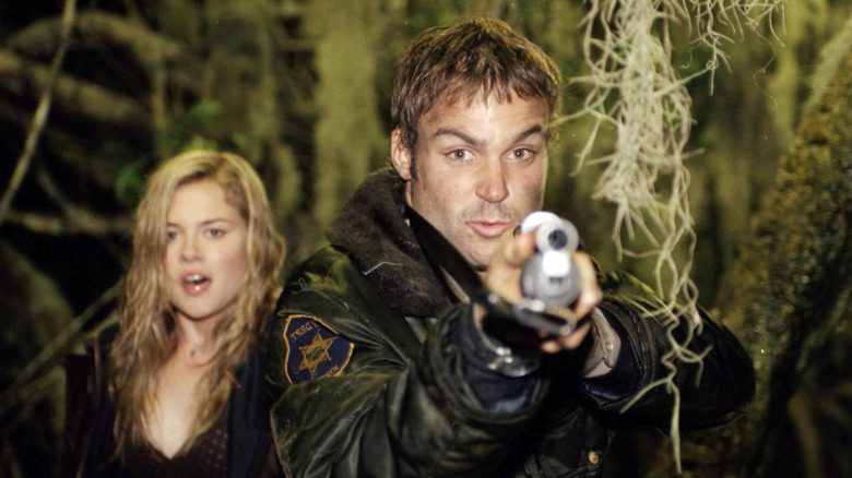 Kyle holding up gun next to Teri (2005)